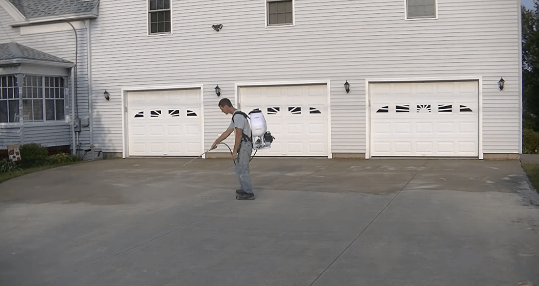 Applying concrete sealer to a concrete driveway